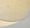 A close-up view of a textured fabric lampshade. Produktbild-Vorschau