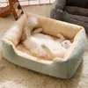 A white cat is sleeping comfortably on its back in a plush pet bed. Produktbild-Vorschau
