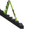 A green Little Giant Dark Horse ladder is positioned on a set of dark gray stairs. Podgląd zdjęcia produktu