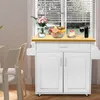 A kitchen cart with a fruit bowl, cake, and wine bottle on top, placed near a window with blinds. Voir les images du produit