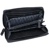 An open black wallet with a floral patterned lining. Produktbild-Vorschau