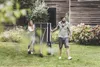 A couple is moving a table tennis table in a garden. Produktbild-Vorschau