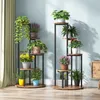 Two multi-tiered plant stands filled with various potted plants are displayed indoors against a light blue wall, with a curtain on the left and a wooden cabinet on the right. Podgląd zdjęcia produktu