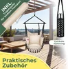 A hanging chair with accessories displayed on a wooden deck with a pergola overhead. Produktbild-Vorschau