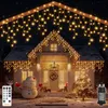 A house decorated with icicle lights for Christmas, with a snowman and a Christmas tree. Produktbild-Vorschau