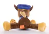A plush toy of Chase from Paw Patrol is shown from the back, sitting on a white background. Produktbild-Vorschau