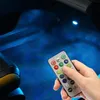 A hand holding a remote control, with blue LED lights illuminating the interior of a car. Produktbild-Vorschau