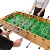 Two people playing foosball on a wooden table. Podgląd zdjęcia produktu