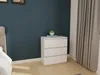 A white chest of drawers with a small plant on top, placed next to a bed and a window with curtains. Náhled obrázku produktu