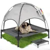 A pug dog lying on a raised dog bed with a canopy, set against a white background with a patch of green grass underneath. Produktbild-Vorschau
