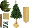 A Christmas tree with its components laid out, including a trunk, burlap wrap, and stand, along with a box. The tree is green and appears to be artificial. Podgląd zdjęcia produktu