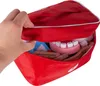 A hand is opening a red doctor's bag, revealing toy medical instruments inside. Anteprima dell’immagine prodotto