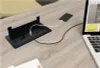 A desk with a built-in power outlet and charging station. Produktbild-Vorschau