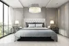 A luxurious bedroom with a large window, a bed, and a chandelier. Produktbild-Vorschau