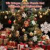 A decorated Christmas tree with owl ornaments and gift boxes at the base. Produktbild-Vorschau