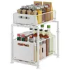 A white two-tier organizer shelf filled with various kitchen items like spice jars, bottles of oil and sauces. Voir les images du produit