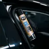 A gloved hand holds a spray can of K2 SIL silicone spray next to a car door seal. Produktbild-Vorschau