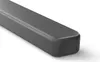 A close-up, angled view of a grey soundbar speaker against a white background. Voir les images du produit