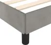 Close-up of a grey upholstered bed frame with wooden slats and black legs. Anteprima dell’immagine prodotto
