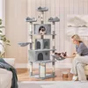 A woman is interacting with cats on a large cat tree in a living room. Produktbild-Vorschau