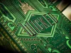 A close-up of a green and gold playing card box with the word "Wicked" embossed on it. Náhled obrázku produktu