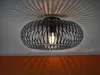 A black, modern ceiling light fixture with a cage-like design, casting intricate shadows on the ceiling. Náhled obrázku produktu