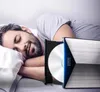 A man is sleeping in bed next to a Zenwire USB 3.0 DVD drive with a disc inserted. Produktbild-Vorschau