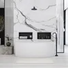 A modern bathroom with a freestanding bathtub, marble accent wall, and black fixtures. Anteprima dell’immagine prodotto