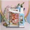 A miniature dollhouse with a spiral staircase and interior furnishings. Anteprima dell’immagine prodotto