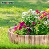 A wooden garden border filled with colorful flowers and greenery, set in a grassy lawn. Náhled obrázku produktu