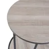 A close-up view of a round table with a wood-grain texture and a dark metal frame. Anteprima dell’immagine prodotto