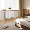 A bedroom scene with a radiator under a window. Produktbild-Vorschau