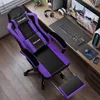 A gaming chair is set up at a desk with a computer and accessories. Produktbild-Vorschau