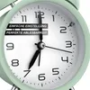 Close-up of a light green analog alarm clock. Produktbild-Vorschau