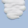 A close-up shot of white foam on a light blue background. Podgląd zdjęcia produktu
