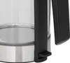 A close-up view of the bottom portion of a glass kettle with a black handle and a silver base. Náhled obrázku produktu