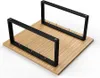 Two black metal frames with metal pins are placed on a wooden surface. Produktbild-Vorschau