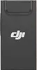 A close-up, front-facing shot of a black DJI mobile data dongle. Produktbild-Vorschau