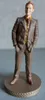 A figurine of a man in a suit standing on a circular base. Produktbild-Vorschau