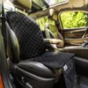 Interior of a car with a black seat protector on the driver's seat. Produktbild-Vorschau