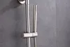 A close-up of a brushed stainless steel shower set mounted on a gray tiled wall. Produktbild-Vorschau