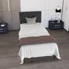 A bedroom scene with a single bed, nightstands, and a lamp. Náhled obrázku produktu