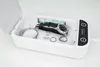 A white UV sterilizer box with a watch, bracelet, and rings inside, with the lid open. Produktbild-Vorschau