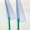 Close-up view of two clear plastic shower door seals with green inserts, attached to glass panels. Water droplets are visible on the seals. Produktbild-Vorschau