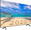 A television displaying a beach scene with the year 2020 written in the sand. Produktbild-Vorschau