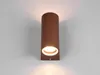 A brown cylindrical wall light fixture with an illuminated opening is mounted on a white wall. Voir les images du produit