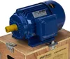 A blue electric motor is placed on a wooden crate, with a white background. Voir les images du produit