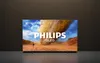 A Philips QLED TV is displayed in a dark room, showing a desert landscape with a tornado on its screen. Náhled obrázku produktu