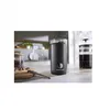 A coffee grinder and a French press are on a kitchen counter, with coffee beans in a jar in the background. Produktbild-Vorschau
