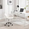 A modern home office setup with a white desk and a white accent chair. Produktbild-Vorschau